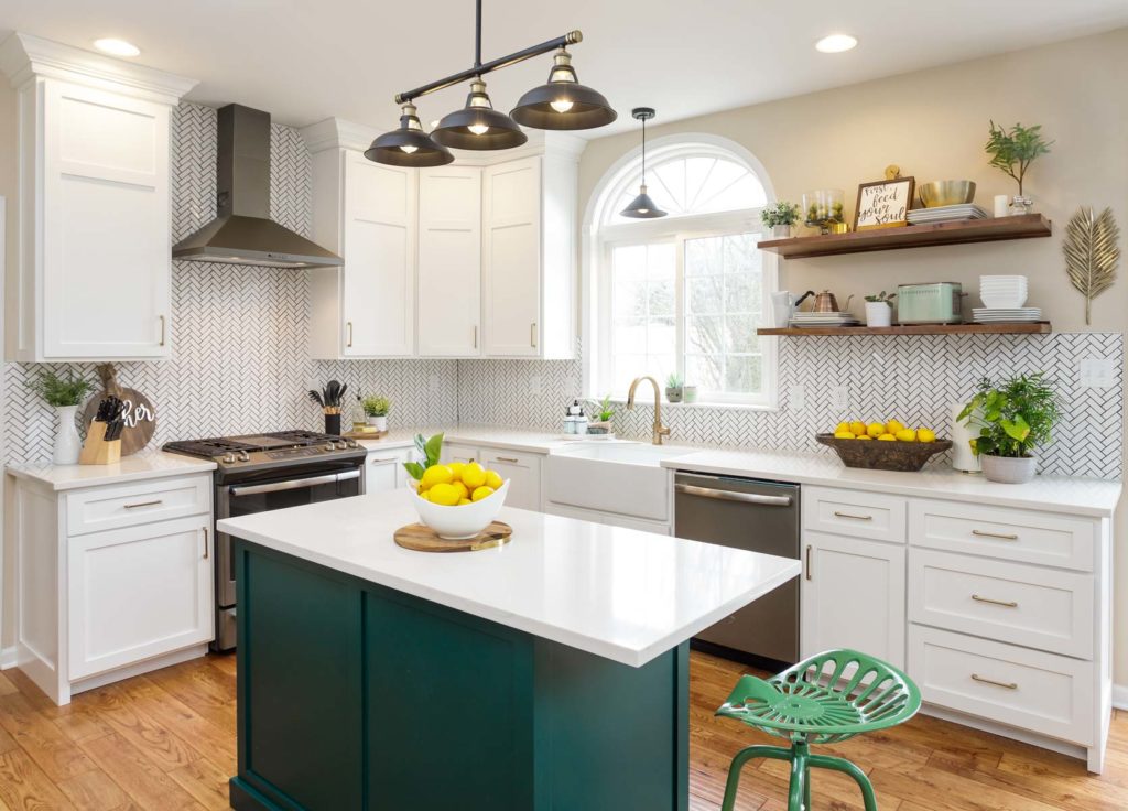 a green kitchen island in a white-painted kitchen