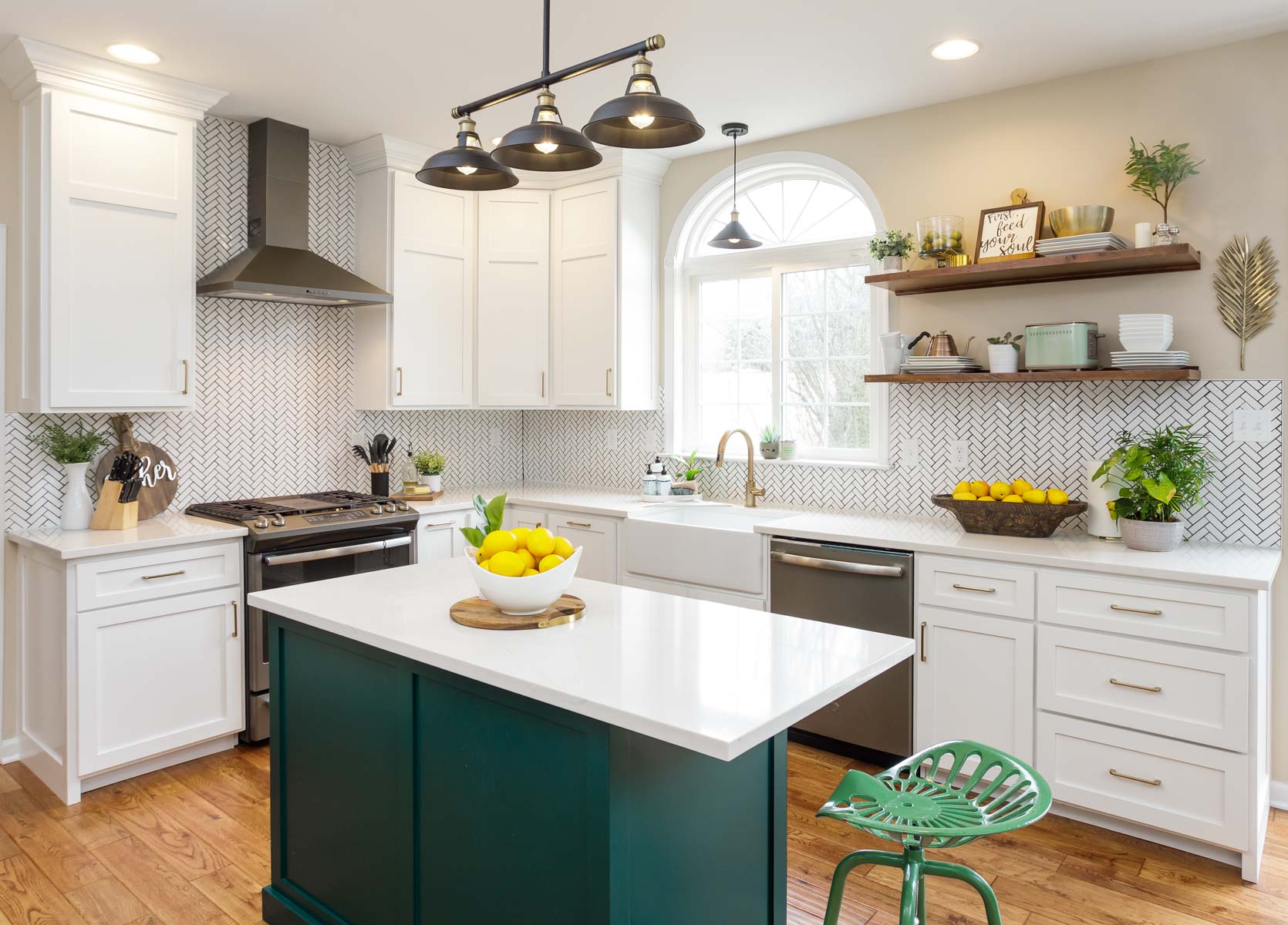 a green kitchen island in a white-painted kitchen